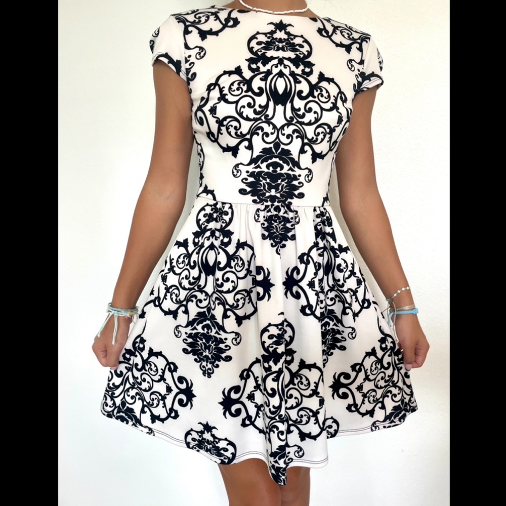 Formal black and white patterned skater dress with mesh back, juniors